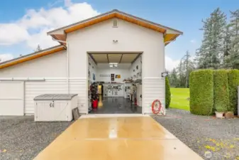 14 foot door, and two storage areas to the left, one attached and one detached from the shop.