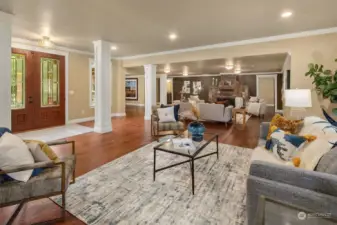 Gorgeous and large living room area divided into 2 with floor to ceiling rock fireplace and a more formal space as you enter