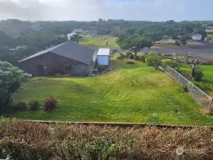 View from deck over the back yard and shop to the ocean.