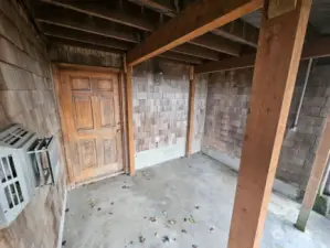 Patio below the living room with a huge storage room.  Special extra strength beams to support the upper deck for possible hot-tub use.