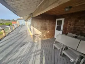 Deck running along the whole back side of home overlooking the yard and shop on out to the ocean.