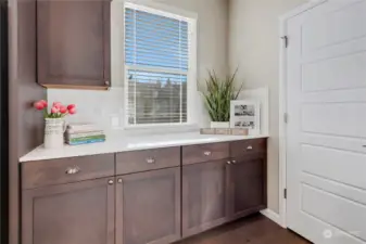 This kitchen offers ample storage, counter space, and a walk-in pantry.