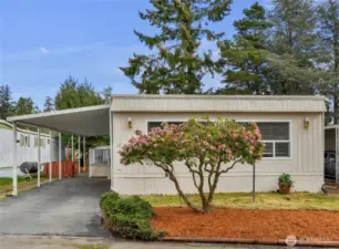 Carport Parking for 2 Cars and a large entry deck.  Lots of gardening space around the home and lawn area up front.