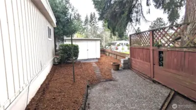 Back fenced in patio looking north towards the shed.