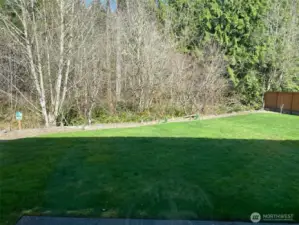 Photo taken by Seller prior to Tenant Occupancy.  Spring daffodils grace the planting border at the back of the yard