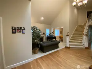 Photo taken by Seller prior to Tenant Occupancy. Elegant curved stairs grace the entry adjacent to the formal living room