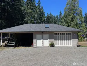 The Shop garage, storage for tractors, mowers, boats and firewood.  Well lit and there's a Heated Tack Room with attic.