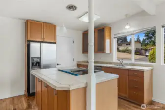 Enjoy views of strollers accessing trails while while cooking.
