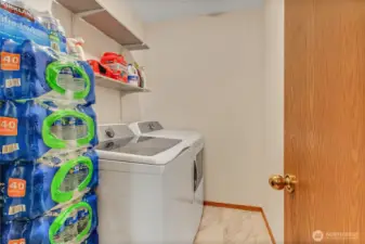 Laundry room with built-in shelving and brand-new tile flooring for a fresh, clean look.