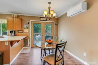 Dining area situated between the kitchen and living room, featuring French doors that open to the outdoor deck—perfect for easy indoor-outdoor entertaining.