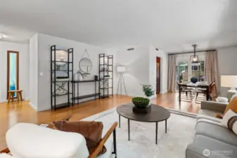 The front door is next to the window on the left. The kitchen is across from the dining table. The wall closing off the kitchen is not load bearing and could be removed.