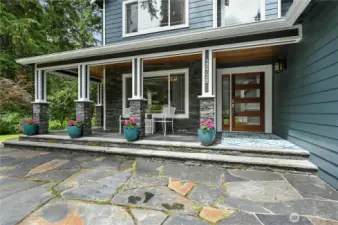 Gorgeous mahogany entry door welcomes you! This lovely flagstone patio wraps around 3 sides of the home.