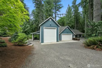 RV garage with 16'doors and 12' wide. Approx 39' deep. Two car garage/workshop on the right with storage above. Covered storage on each "wing" for extra vehicles or tractors.