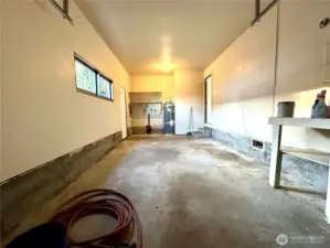 Fairly deep garage. Exterior door on the left. Kitchen door on the right, W/D hookup.