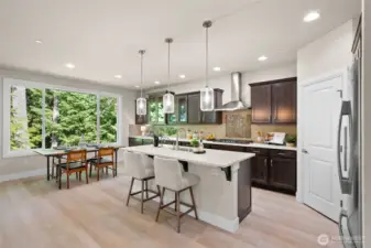The open concept design blends the kitchen, island seating and dining room into one inviting space.