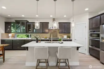 Cabinets galore in this terrific kitchen!  Quartz counters and stylish pendant lighting over the island