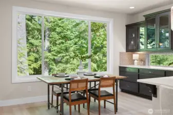 A wall of windows brings the outdoors in overlooking evergreens for year round privacy.  The dining space can easily accomodate a table for 8 to 10.