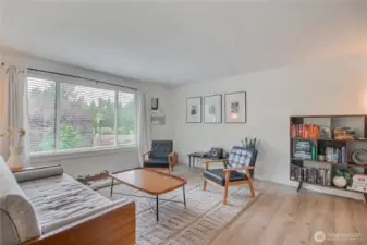 Living room has tons of natural lighting and fireplace.