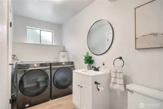Laundry room downstairs with half bathroom.