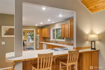 Large kitchen is open to the living and dining rooms and has this great bar for casual dining, homework with the kiddos, or just visiting while cooking