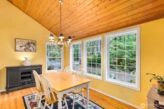 Sunny breakfast room with vaulted knotty pine ceilings is a great casual dining spot.