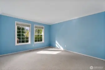 Bedroom number three with views to the rear yard and deck