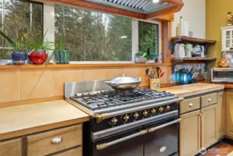 Spacious kitchen with ample storage and prep areas, brightened by abundant natural light