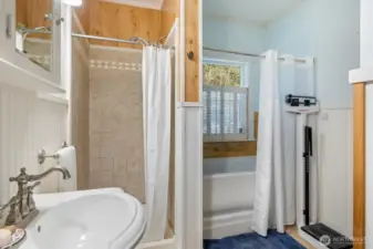 Spacious primary bathroom with a 5-piece layout and elegant wainscoting