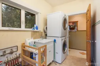 Functional utility room with generous storage options and utility sink.