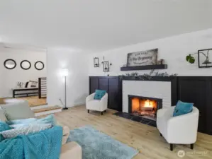 Another view of living area with cozy fireplace.