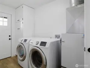 Utility room with exterior door to the back deck.