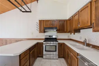 Kitchen with stainless appliances, gas range and open to breakfast nook