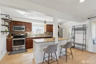 Large kitchen with stainless appliances, granite counters