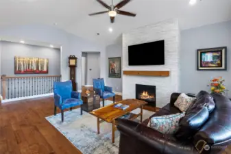 Main level Great Room with gas fireplace and ceiling fan
