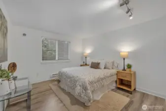 Primary Bedroom is on the Creekside area of the unit.  Quiet, tranquil, generous closet.  Primary bedroom has a portable air conditioning unit vent/exhaust if you need additional cooling in the summer.  (Note vent to the upper left of the window.)  AC exhaust vents also in the Living Room, and second bedroom.