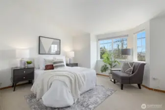 The primary bedroom has east facing windows and view of the Cascades.