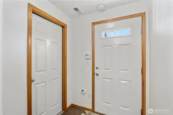 The front door is on the right and the other door leads to the garage.  The entry also has a coat closet.