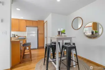 Spacious great room has space for a dining table and there's a breakfast bar in the kitchen, too.