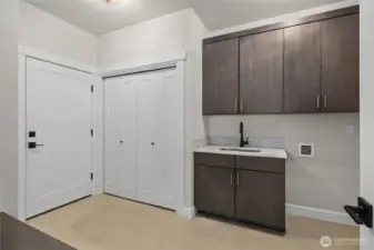 Large laundry room with utility sink.
