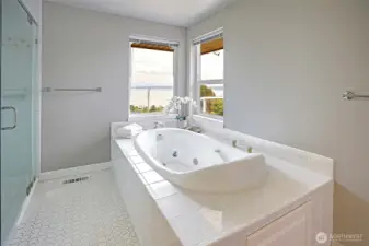 Relax in the jetted tub with the mountains and water in the background