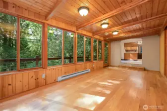 A massive sunroom facing the gorgeous territorial views is flooded with natural light. Through the pass through beyond you'll enter the clean, efficient kitchen space.