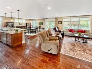 View of the great room from the foyer...You will love all windows that bring in so much natural light throughout the changing seasons rich engineered wood floors, built-ins and gas fireplace.