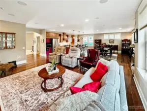 The gathering room with engineered hardwood floors, can lighting, gas fireplace and surround speaker system.