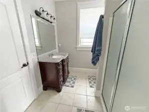 The 3/4 bath with tile floor offers access from both guest bedrooms.