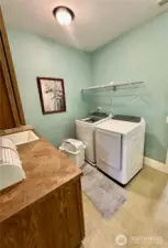 Utility room with cabinet space, laundry sink and access to the hobby/craft room.
