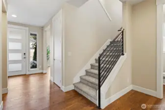 Modern railing with freshly cleaned carpets leading up to spacious second floor.