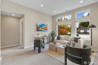 Loft area with flexibility for additional living space. Grand 10 ft ceilings and custom mounted TV.