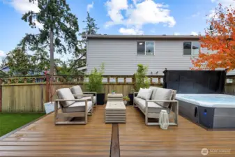 Entertainers dream backyard with Trex decking, pet friendly turf, and Hot Springs Highlife Collection Hot Tub, BBQ Gas Hookup