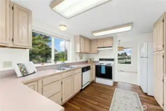 Ample cabinets to the right provide ideal space for all your pantry items.
