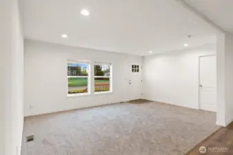 Large light filled living room.  Door to the right in the picture leads to the primary bedroom.